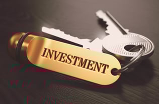 Keys with Word Investment on Golden Label over Black Wooden Background. Closeup View, Selective Focus, 3D Render. Toned Image. Keys with Word Investment on Golden Label over Black Wooden Background. Closeup View, Selective Focus, 3D Render. Toned Image.